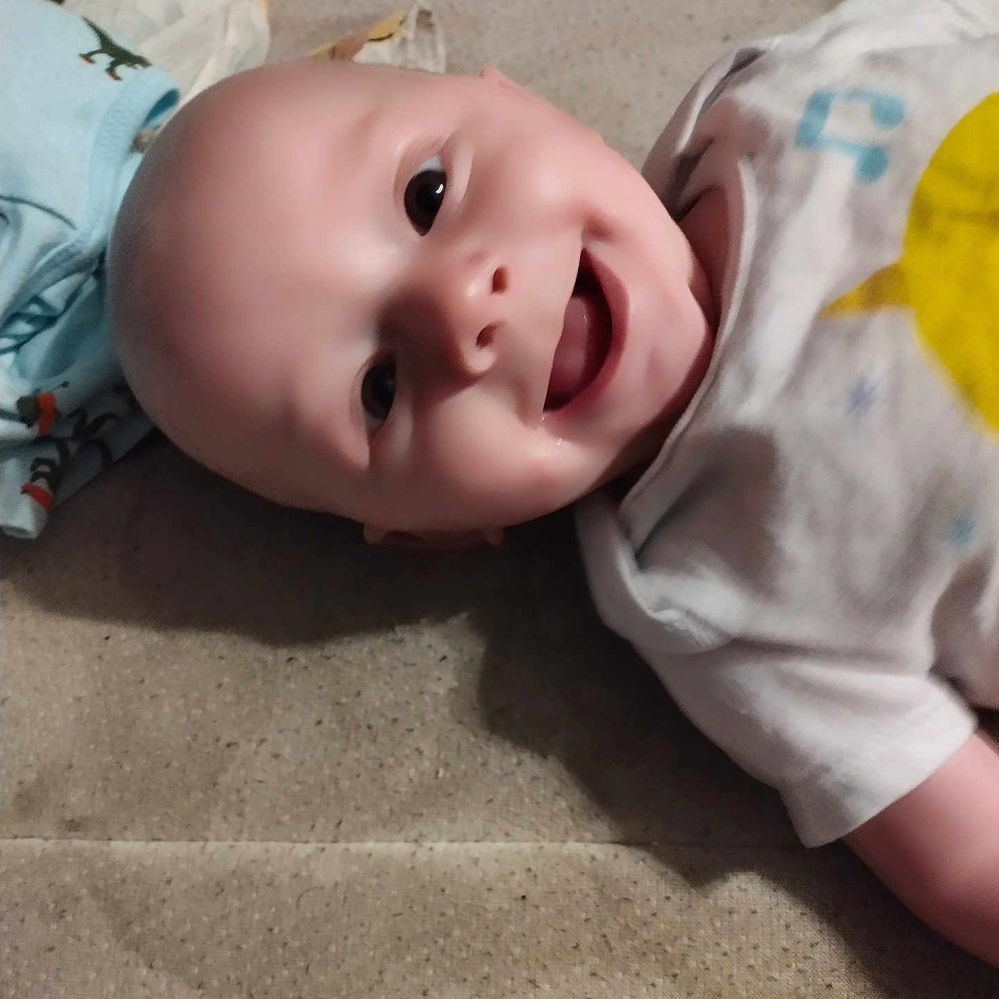 Zayden joined the competition — help win amazing prizes! applique, baby, babylaughing, bodypart, clothing, face, finger, hand, happy, head, laughing, mouth, newborn, pattern, person, photography, portrait, smile, t_shirt, toy