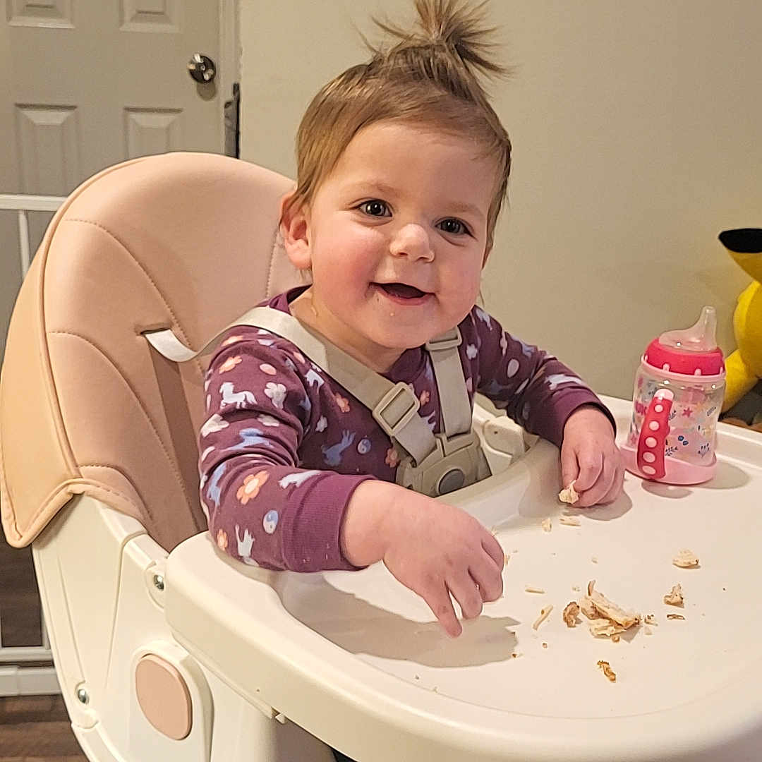 Freyja joined the competition — help win amazing prizes! baby, bodypart, chair, cutlery, diningtable, eating, face, finger, food, furniture, hand, head, highchair, person, photography, portrait, sitting, spoon, table, wood