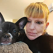 Luna Wells is registered to the contest to win money with this photo: woman, dog, french_bulldog, puppy, indoor, close_up, portrait, couch, pet, companion, relaxing, face, ear, furniture, human, animal, black_and_white, nose, snout, expression