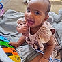 Seraphina joined the competition — help win amazing prizes! baby, child, smiling, toy, piano, colorful, blanket, plush_toy, happy, cute, indoors, person, sitting, clothing, infant, play, young_child, hand, foot, face