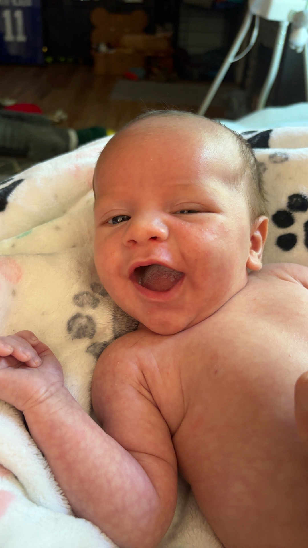 Trustyn is registered to the contest to win money with this photo: baby, infant, smiling, face, skin, arm, blanket, paw_print, lying_down, happy, newborn, expression, cute, indoors, soft_texture, closeup, person, child, portrait, cheerful