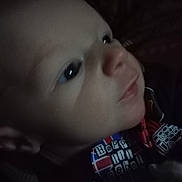 Dakota is registered to the contest to win money with this photo: baby, close_up, face, child, infant, expression, clothing, colorful, text, soft_lighting, portrait, cute, young, person, indoor, skin, head, eyes, nose, mouth