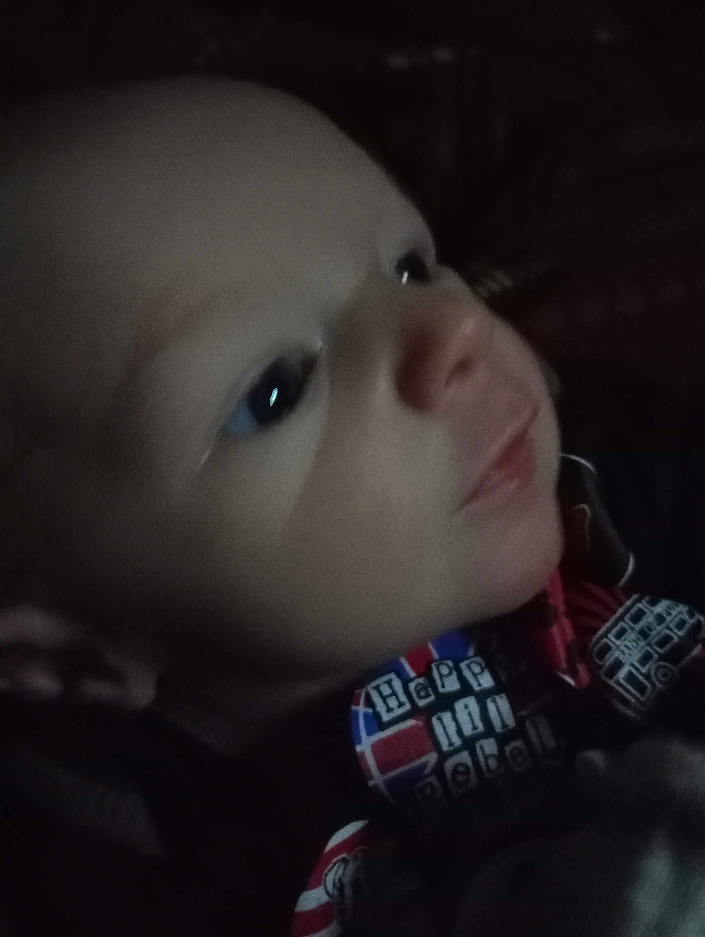 Dakota is registered to the contest to win money with this photo: baby, close_up, face, child, infant, expression, clothing, colorful, text, soft_lighting, portrait, cute, young, person, indoor, skin, head, eyes, nose, mouth