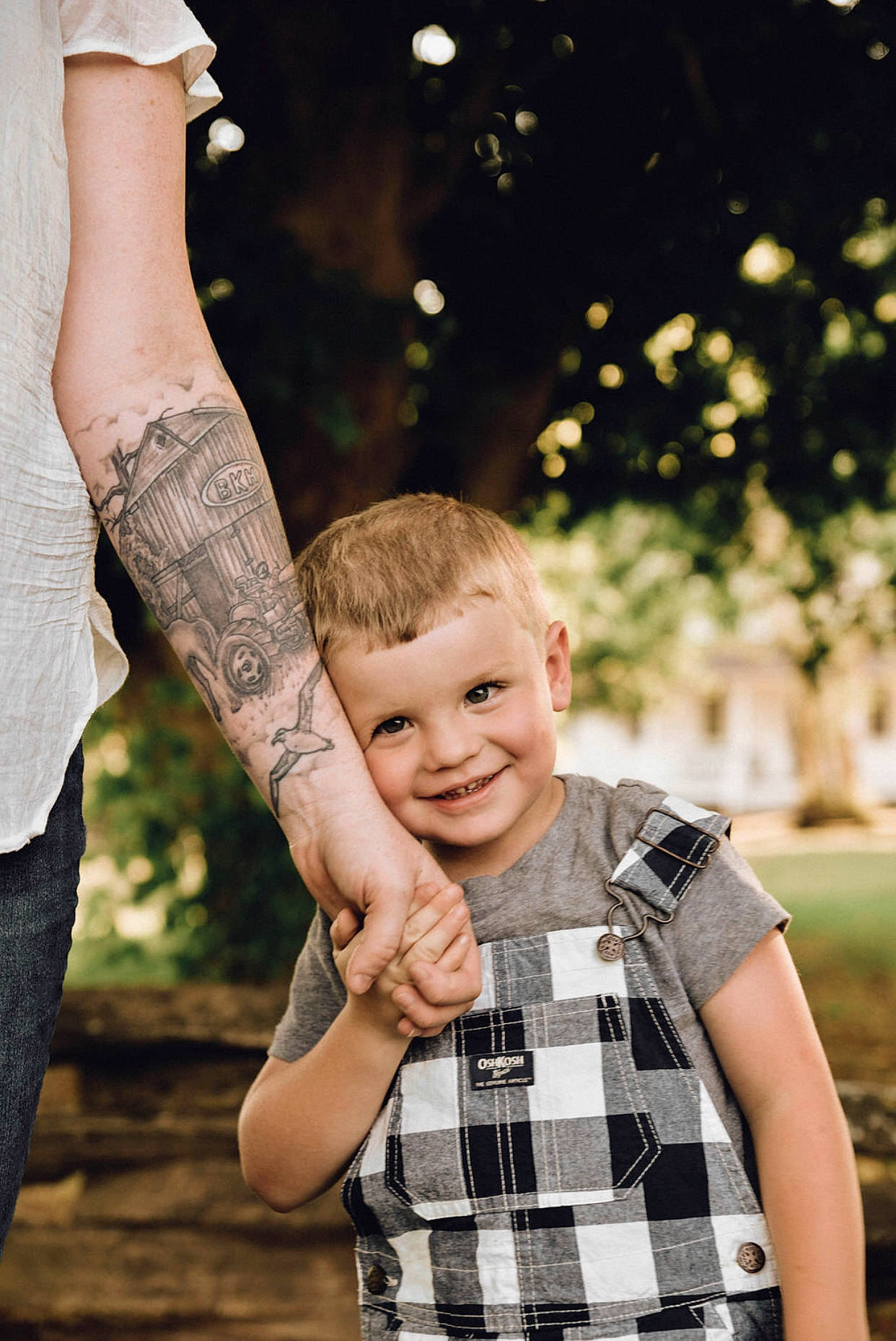 Brice is registered to the contest to win money with this photo: arm, child, design, finger, fun, gesture, hand, holding_hands, interaction, joy, leg, male, pattern, people, person, photograph, photography, plaid, skin, smile