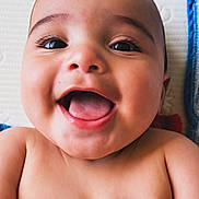 Jaxen joined the competition — help win amazing prizes! baby, smiling, happy, face, hand, nail_polish, yellow_nails, red_cloth, skin, portrait, cute, infant, lying_down, closeup, cheerful, child, expression, background, texture, fingers