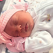 Jaylania joined the competition — help win amazing prizes! baby, newborn, sleeping, pink_hat, bow, pajamas, blanket, footprint_pattern, infant, cute, peaceful, soft, clothing, headwear, sleep, rest, closeup, adorable, child, portrait