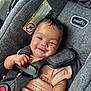 baby, child, car_seat, smile, happiness, infant, clothing, seatbelt, safety, cute, portrait, person, indoors, fabric, strap, head, hand, skin, seat, young