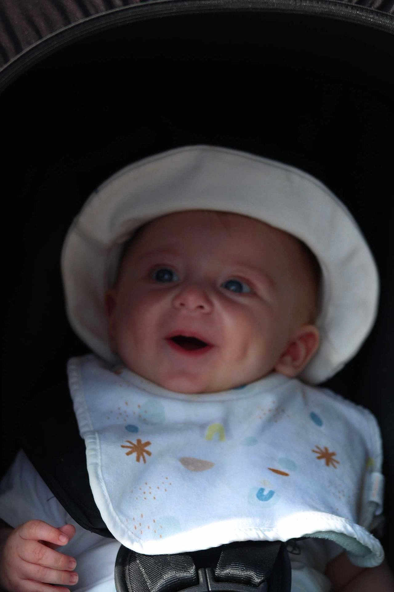 Ayden joined the competition — help win amazing prizes! baby, infant, smiling, hat, bib, stroller, child, face, blue_eyes, happy, cute, hand, clothing, portrait, seatbelt, baby_clothes, expression, dimple, closeup, young