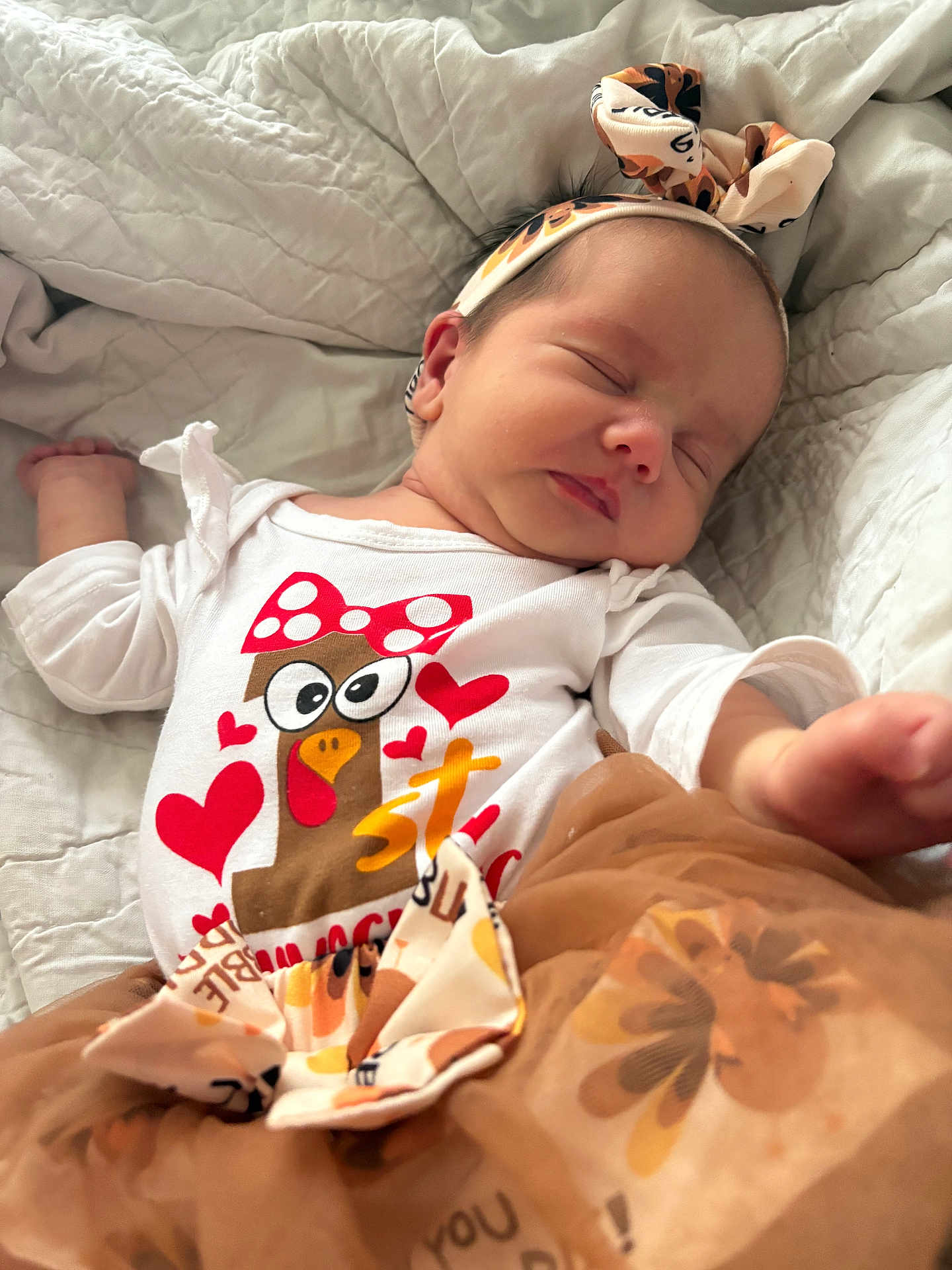 Stella is registered to the contest to win money with this photo: baby, sleeping, headband, white_blanket, cartoon, hearts, cute_outfit, skirt, infant, peaceful, closeup, soft_texture, child, apparel, resting, adorable, face, person, indoors, newborn