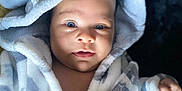 Hunter is registered to the contest to win money with this photo: baby, blanket, bonnet, clothing, face, happy, hat, head, hood, person, photography, portrait