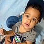 Hunter joined the competition — help win amazing prizes! toddler, child, cap, curious, indoor, soft_blanket, toy, holding_object, green_eyes, grey_shirt, navy_shorts, cute, portrait, baby, sitting, hand, face, expression, curly_hair, closeup
