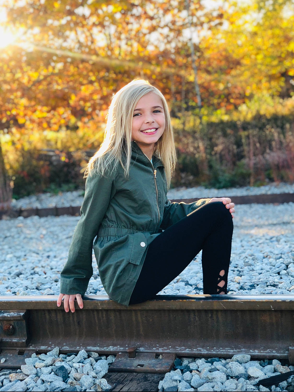 Jadyn is registered to the contest to win money with this photo: autumn, bank, beauty, blond, jeans, joy, leaf, leggings, long_hair, people, people_in_nature, person, photo_shoot, photograph, photography, portrait, portrait_photography, sitting, smile, sunlight