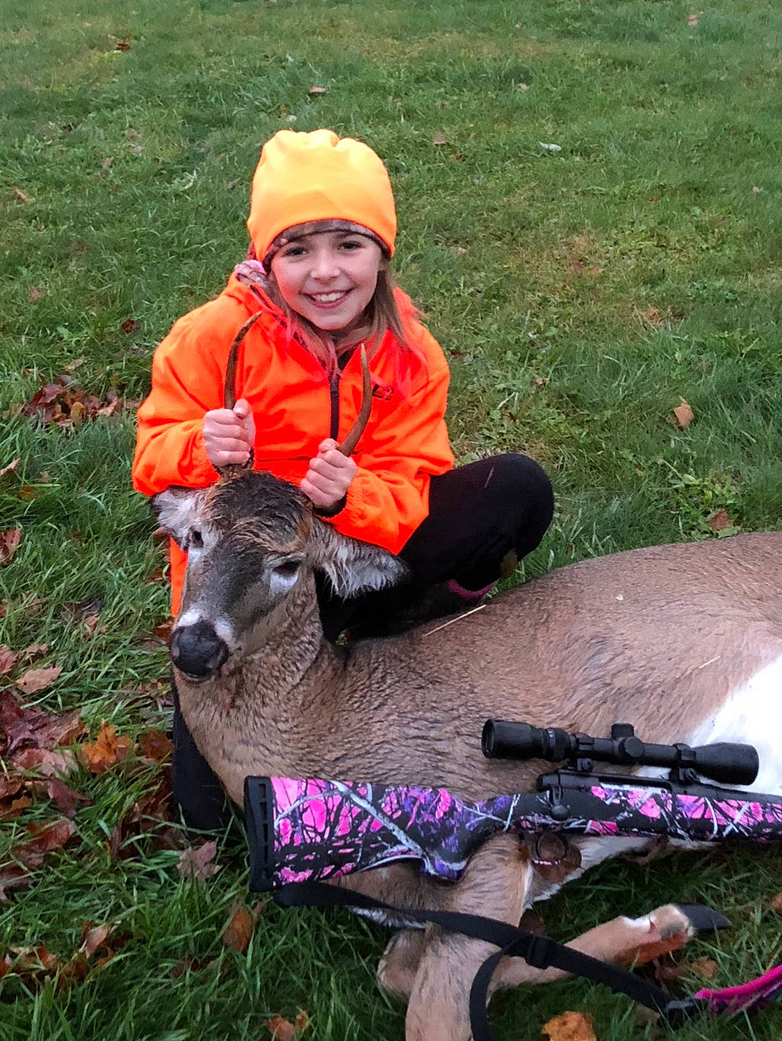 Jadyn is registered to the contest to win money with this photo: deer, deer_hunting, fawn, grass, headwear, joy, person, plant, recreation, wildlife_biologist