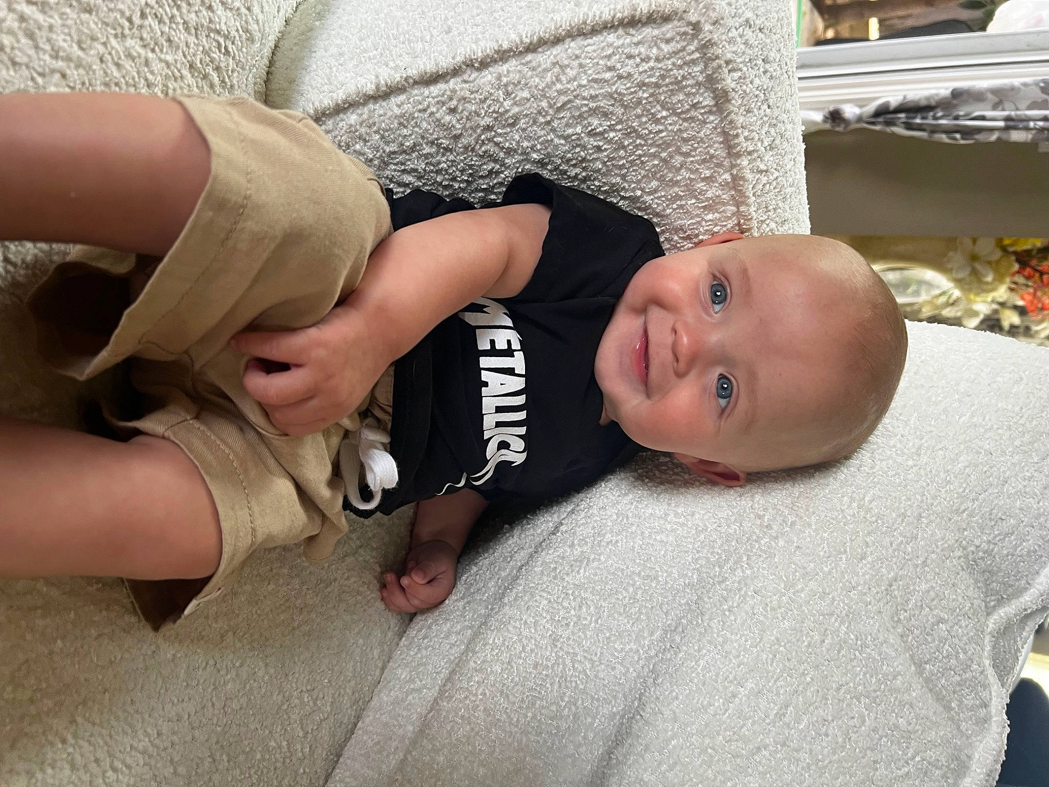 Conner joined the competition — help win amazing prizes! baby, baby_toddler_clothing, child, comfort, elbow, finger, flooring, foot, fun, human_leg, joy, leg, linens, pattern, person, sitting, skin, smile, thigh, thumb