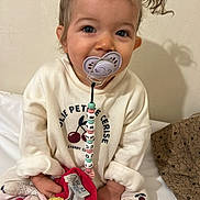 Louise a rejoint le concours — aidez-le/la à gagner de superbes lots ! beads, candid, cherry_pattern, child, cozy_clothing, cute, face, hands, indoor, innocent, pacifier, pigtails, playful, sitting, smiling, soft_toy, toddler, toy, white_background, young_child