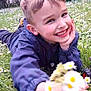 Mathéo participe au concours pour gagner de l'argent avec cette photo : child, boy, smiling, flowers, daisies, grass, outdoor, nature, greenery, happy, casual_clothing, playful, garden, spring, portrait, young, face, hand, toy_car, daylight