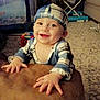Joshua is registered to the contest to win money with this photo: baby, child, smiling, hat, striped_clothing, indoor, carpet, toy, furniture, couch, hands, face, home, infant, happy, person, playpen, living_room, blanket, cute