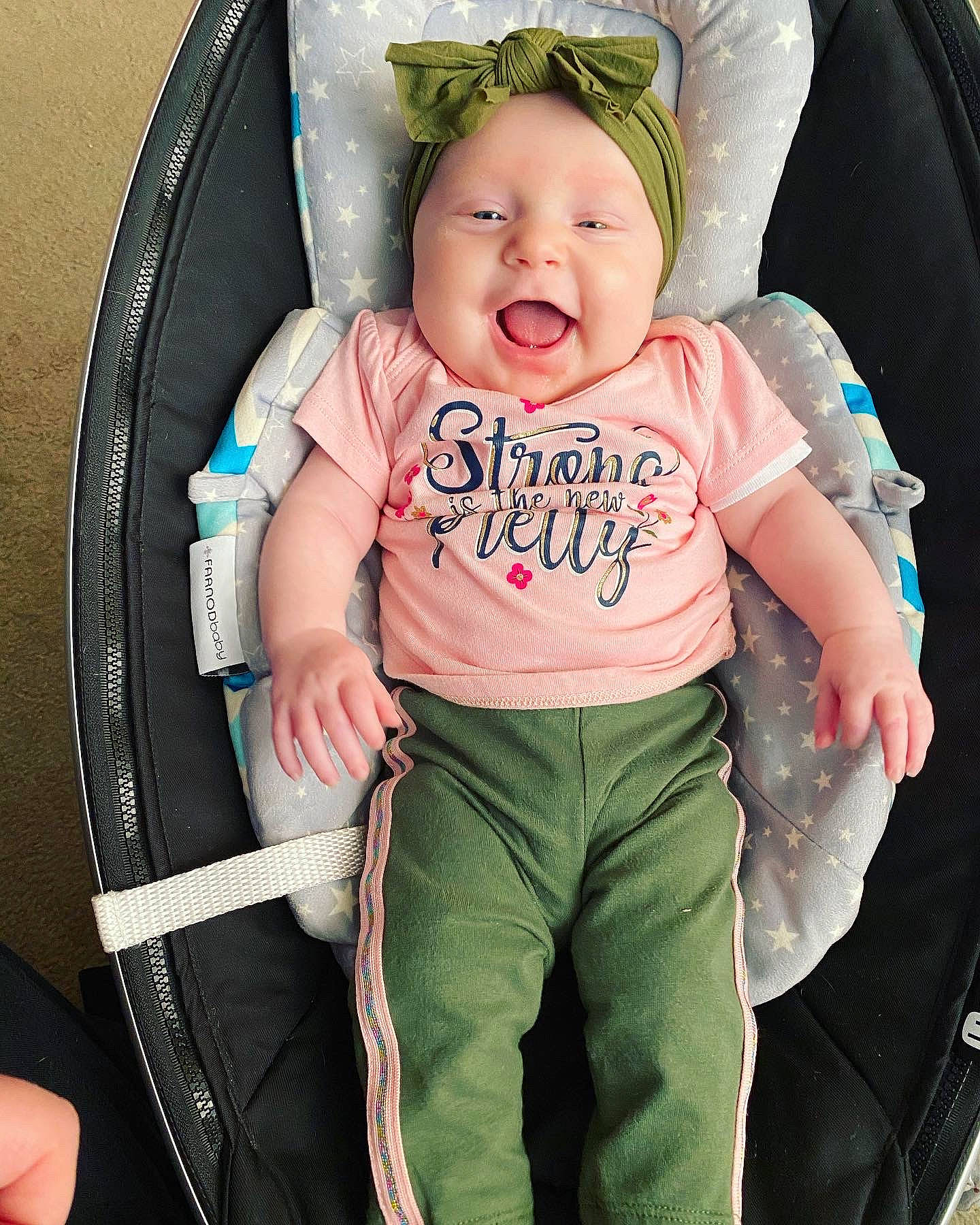 Miley is registered to the contest to win money with this photo: abdomen, baby, baby_carriage, baby_in_car_seat, baby_products, car_seat, cheek, child, eye, fun, jeans, person, product, skin, smile, toddler, tooth