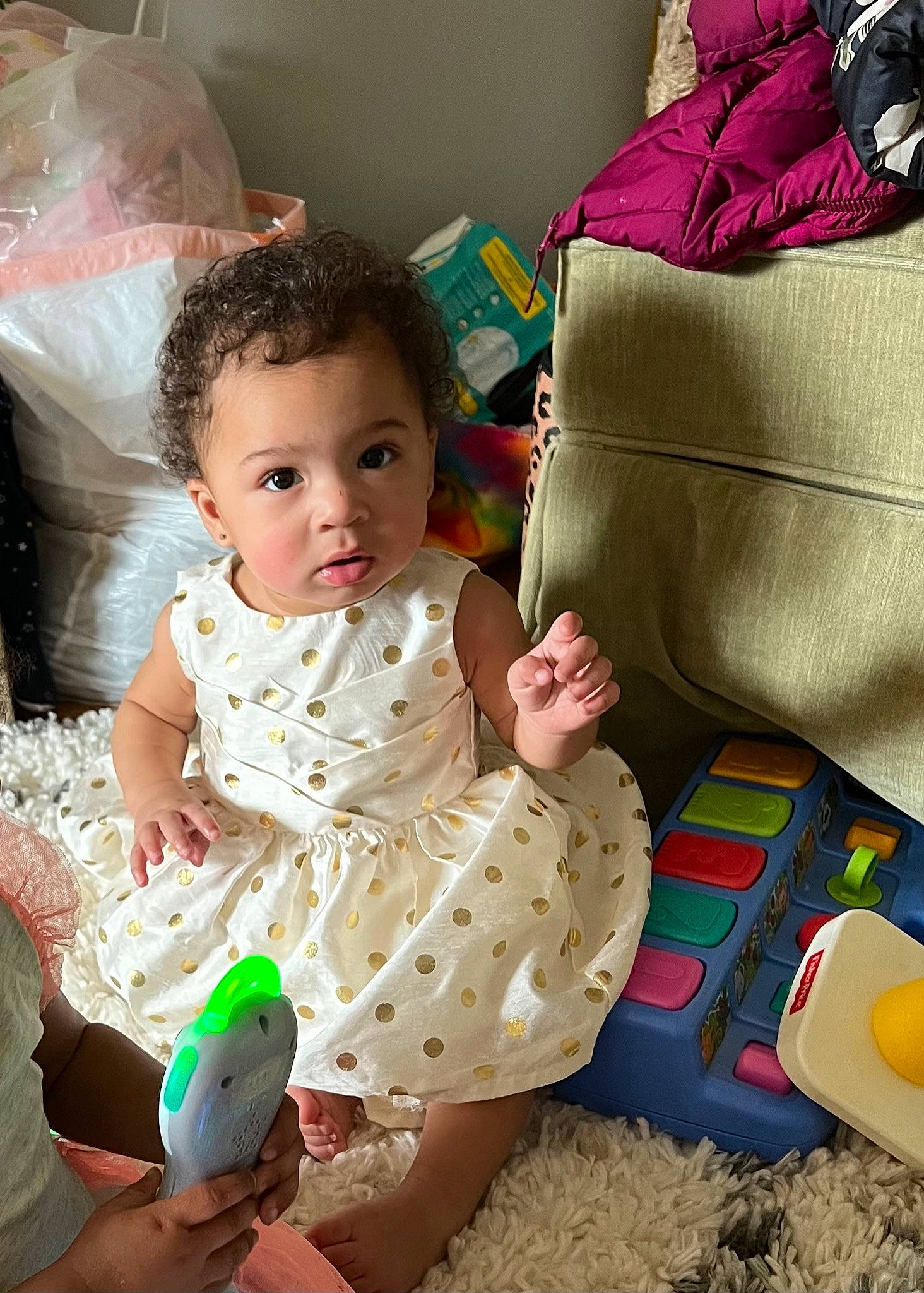 Baby T is registered to the contest to win money with this photo: baby, baby_toddler_clothing, cheek, comfort, dress, fun, hairstyle, hand, happy, head, human_body, leg, mammal, person, pink, product, skin, textile, toddler, white