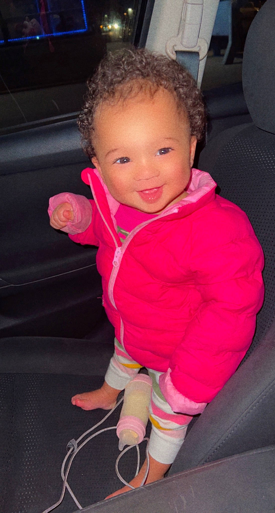 Baby T is registered to the contest to win money with this photo: baby_toddler_clothing, cheek, comfort, cool, eye, face, finger, head, human_body, joy, leg, lip, mouth, nose, outerwear, person, pink, purple, skin, sleeve