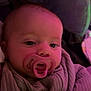 baby, infant, pacifier, swaddle, blanket, closeup, portrait, face, eyes, indoor, pink_lighting, cushion, bedding, cozy, newborn, hands, soft_texture, sleepy, looking_at_camera, nursery