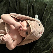 Vivian joined the competition — help win amazing prizes! baby, child, towel, blanket, infant, hand, face, eyes, skin, cute, cozy, lying_down, indoors, plush, soft, person, newborn, wrapped, expression, comfort
