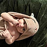 baby, child, towel, blanket, infant, hand, face, eyes, skin, cute, cozy, lying_down, indoors, plush, soft, person, newborn, wrapped, expression, comfort