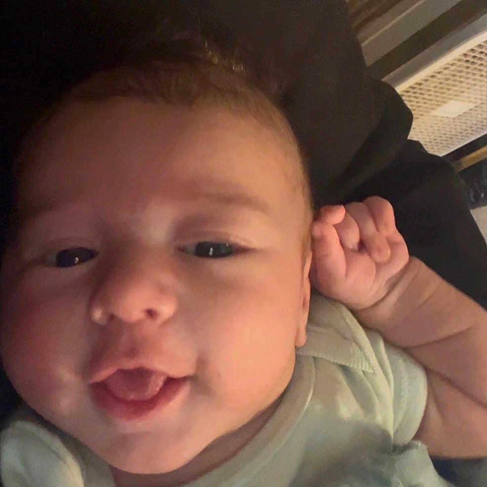 Daxton joined the competition — help win amazing prizes! baby, blanket, child, closeup, cozy, cushion, cute, face, hand, happy, head, indoor, infant, onesie, person, portrait, skin, smile, soft, young