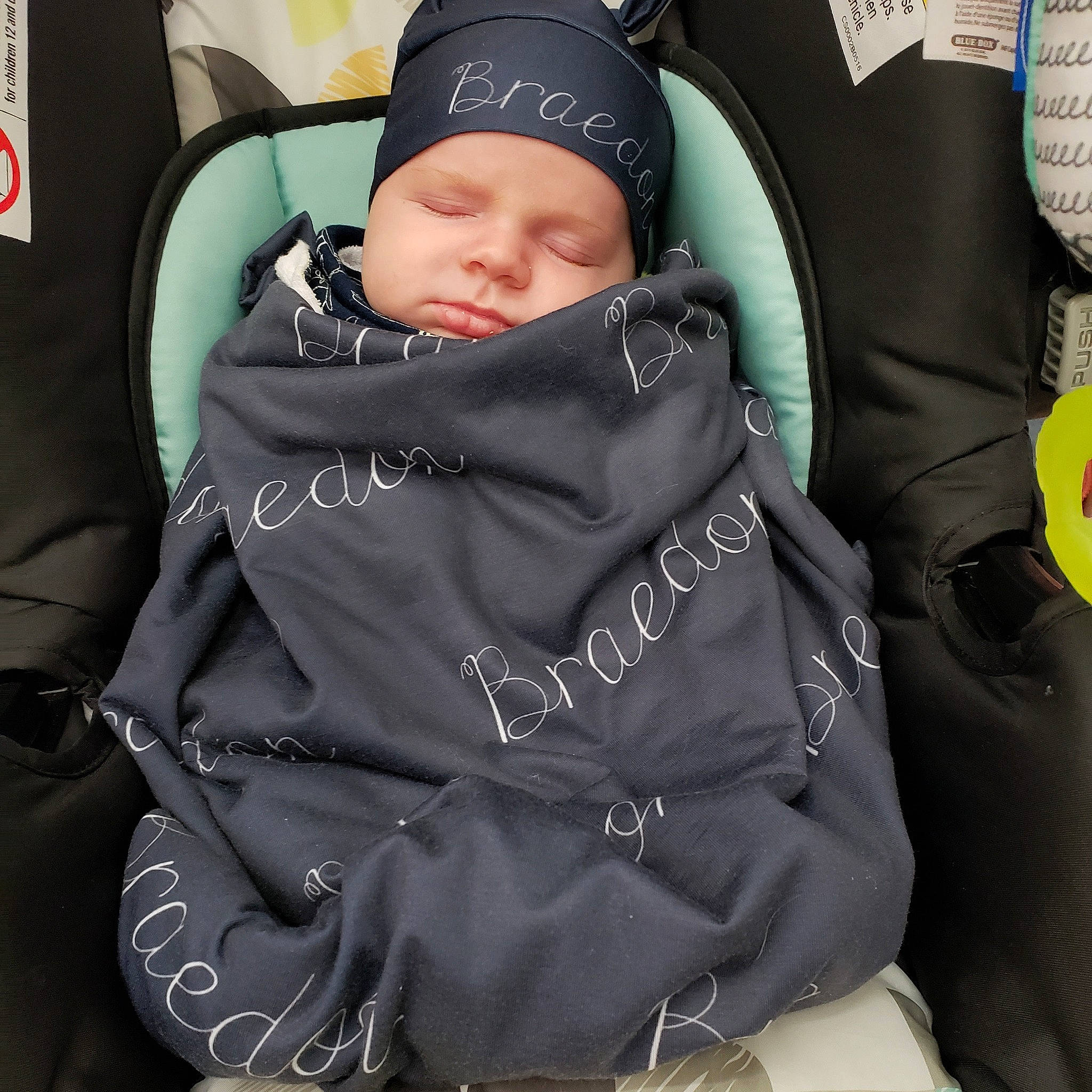 Braedon is registered to the contest to win money with this photo: baby, baby_carriage, baby_products, car_seat, child, comfort, headgear, headwear, jacket, person, personal_protective_equipment, product, toddler