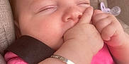 Aria-Louise is registered to the contest to win money with this photo: baby, bracelet, car_seat, child, closeup, comfort, cute, face, hand, indoors, infant, peaceful, pink_clothing, portrait, relaxed, resting, seatbelt, skin, sleeping, young
