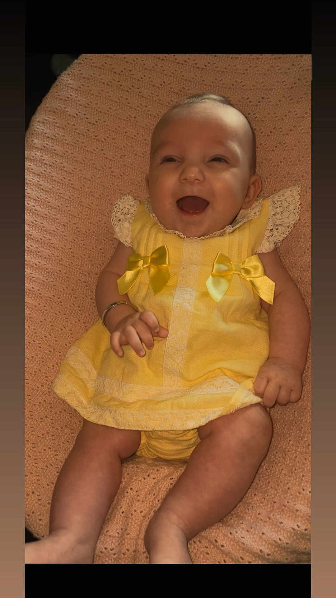 Aria-Louise is registered to the contest to win money with this photo: baby, child, smiling, yellow_dress, lace, bows, blanket, happy, infant, cute, portrait, people, skin, hand, legs, sitting, indoors, closeup, person, baby_clothes