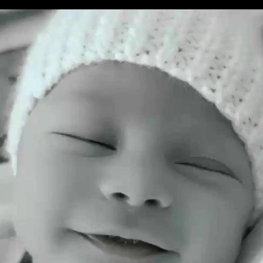 Lucas is registered to the contest to win money with this photo: baby, black_and_white, blanket, child, close_up, cozy, cute, face, hat, headwear, infant, knitted_hat, newborn, peaceful, portrait, rest, sleeping, smile, soft_texture, young