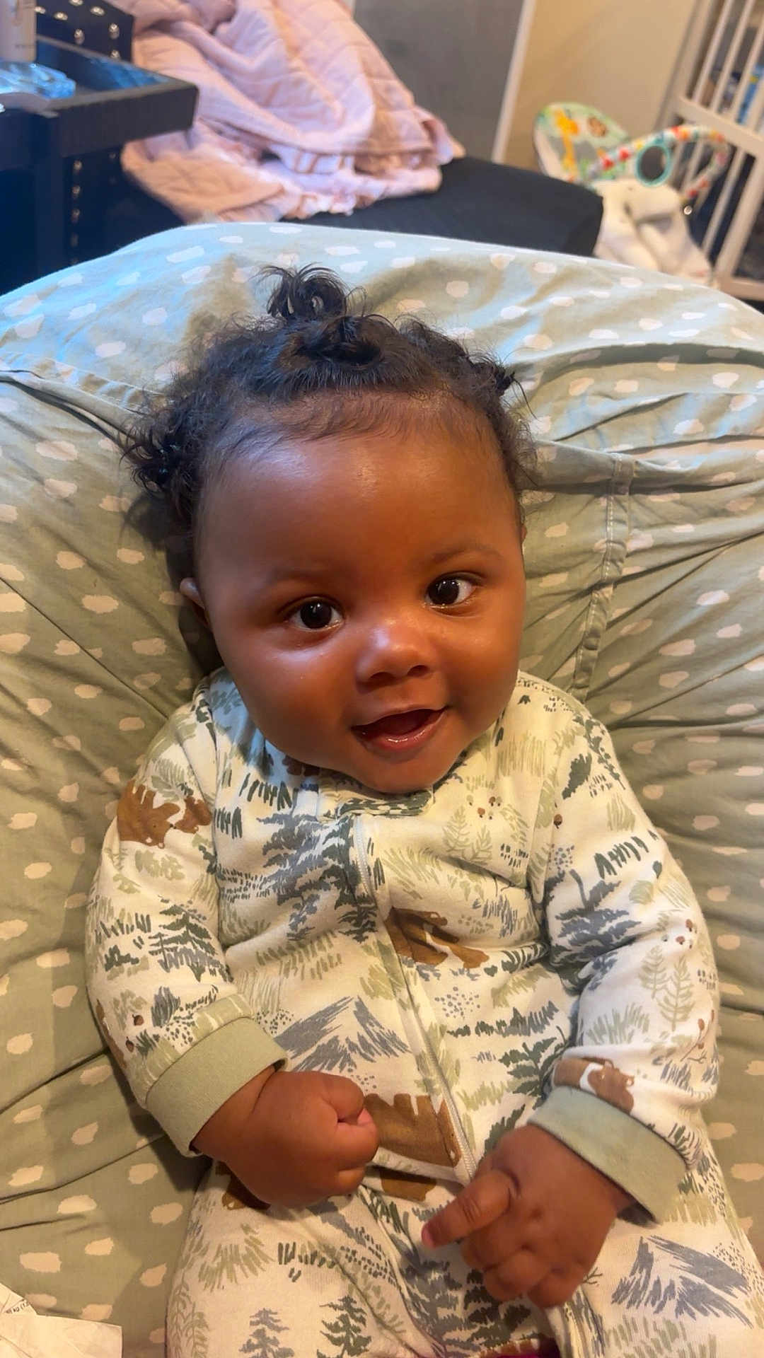 Jream joined the competition — help win amazing prizes! baby, child, smiling, onesie, hair_buns, cushion, polka_dot, indoor, cozy, patterned_clothing, happy, infant, person, cute, portrait, furniture, hand, face, sitting, comfort