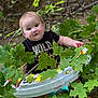baby, child, infant, outdoor, nature, green_leaves, tree_branch, baby_chair, wet_hair, black_shirt, play_toy, curious, sitting, face, person, young_child, smiling, cute, woodland, summer