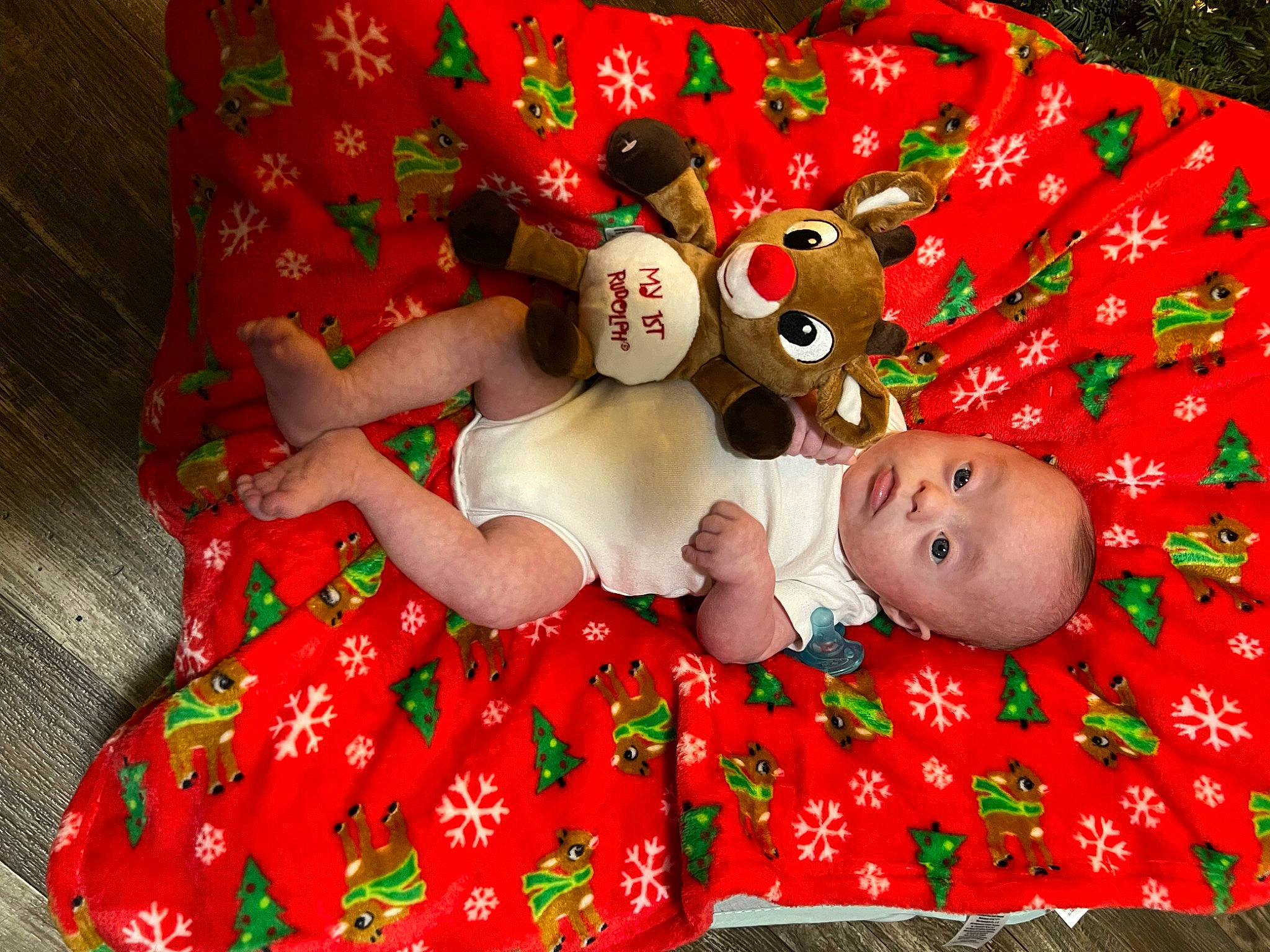 Lamont is registered to the contest to win money with this photo: baby, baby_toddler_clothing, carmine, child, christmas, christmas_eve, event, fictional_character, fun, grass, happy, holiday, linens, pattern, person, red, room, sleeve, textile, toddler