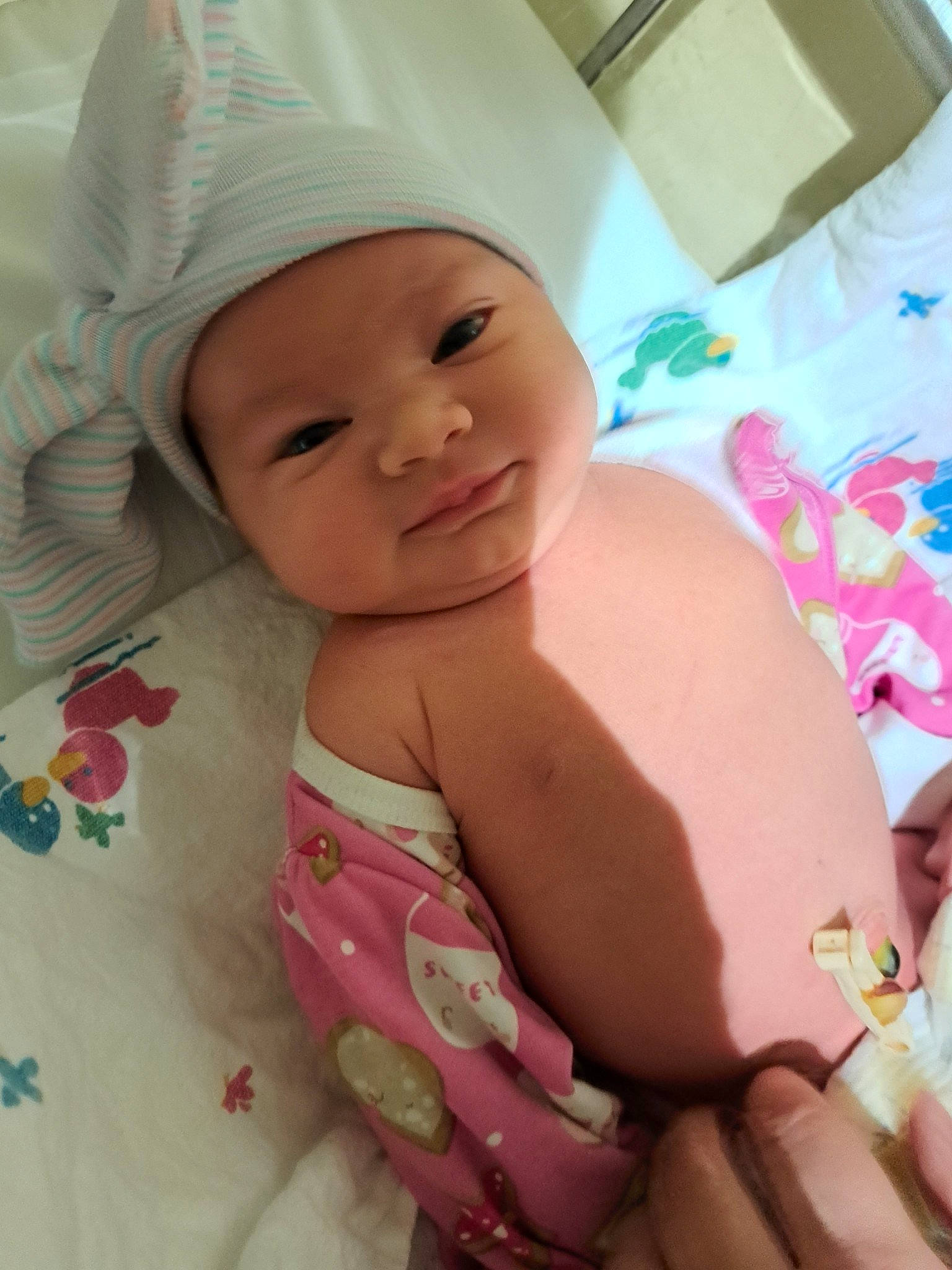 Amber is registered to the contest to win money with this photo: baby, cap, cheek, comfort, face, facial_expression, finger, happy, hat, head, headwear, lip, mouth, nose, organ, person, pink, skin, smile, textile