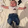 Treyvon is registered to the contest to win money with this photo: adorable, baby, bed, blanket, child, clothing, cute, denim_pants, indoor, infant, lying_down, onesie, pacifier, person, relaxed, remote_control, smiling, socks, soft_texture, white