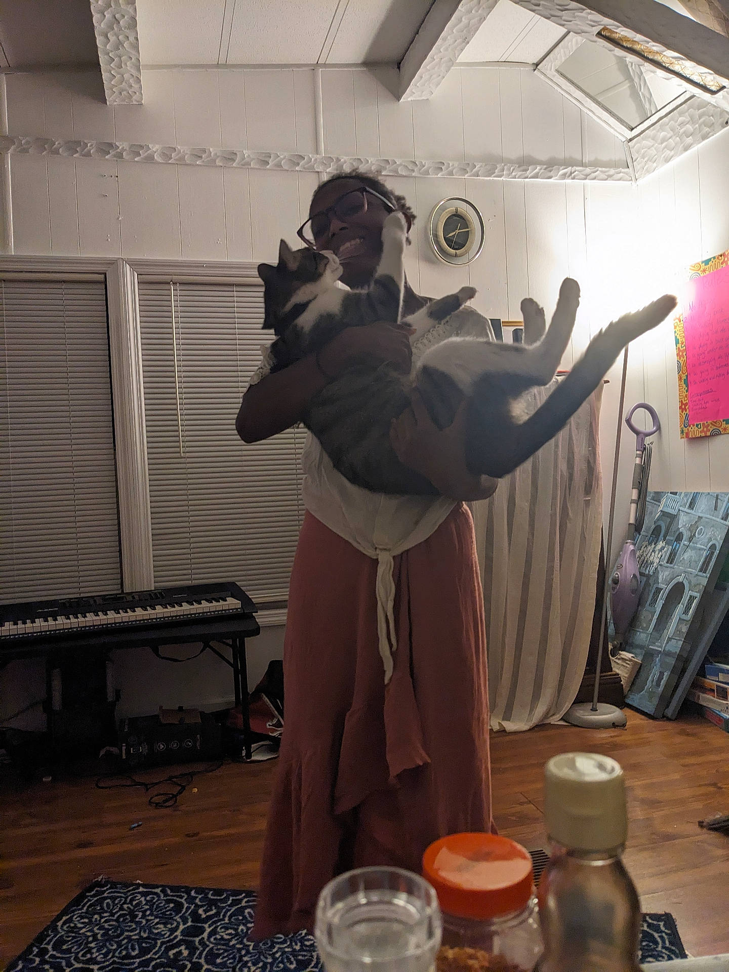 adult, architecture, building, clothing, diningtable, dress, furniture, hardwood, indoors, interiordesign, keyboard, livingroom, male, man, musicalinstrument, person, piano, room, table, wood