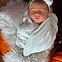 baby, sleeping, white_bow, headband, blanket, wrapped, fluffy_rug, pumpkin, autumn, cozy, soft_texture, infant, child, peaceful, indoors, portrait, cute, newborn, resting, warm