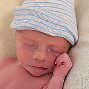 Dean is registered to the contest to win money with this photo: newborn, baby, infant, sleeping, hat, striped_hat, hand, closed_eyes, skin, face, resting, blanket, soft_texture, peaceful, cute, portrait, closeup, human, child, newborn_baby