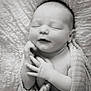 baby, newborn, sleeping, blanket, wrapped, black_and_white, peaceful, infant, cute, soft_texture, fingers, toes, closeup, portrait, child, sleep, serene, resting, cocooned, toddler