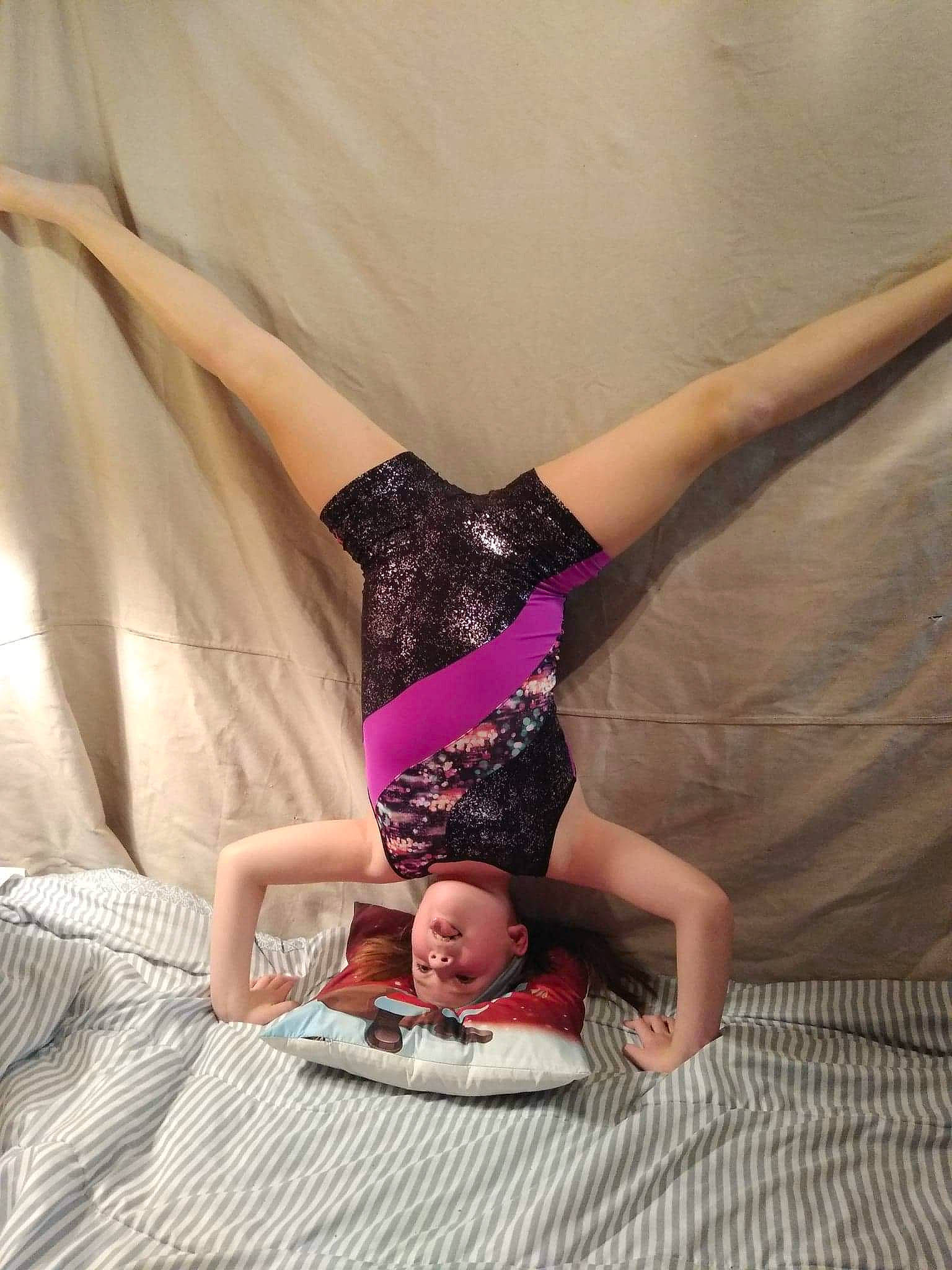 Abigail is registered to the contest to win money with this photo: barefoot, bed, comfort, elbow, finger, flooring, foot, fun, headwear, human_body, human_leg, joint, knee, leg, magenta, person, pink, sportswear, textile, thigh