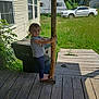 Elana is registered to the contest to win money with this photo: barefoot, camper, car, cat, child, curious, daylight, deck, grass, house, nature, outdoor, plants, post, standing, sunny, toddler, trash_bin, windows, wooden_porch