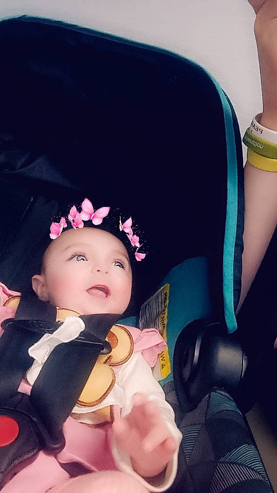 Elana joined the competition — help win amazing prizes! baby, baby_carriage, baby_products, beauty, black_hair, car_seat, car_seat_cover, child, comfort, cool, costume_hat, happy, hat, head, head_restraint, headgear, human_body, person, steering_wheel, toddler