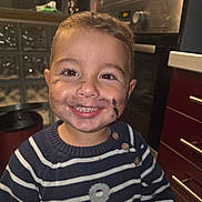 Valentino a rejoint le concours — aidez-le/la à gagner de superbes lots ! anchor_symbol, buttoned_sweater, cabinet, child, cute, face_paint, happy, home, indoors, kitchen, marker, messy_face, oven, person, portrait, smiling, striped_clothing, sweater, toddler, young_child