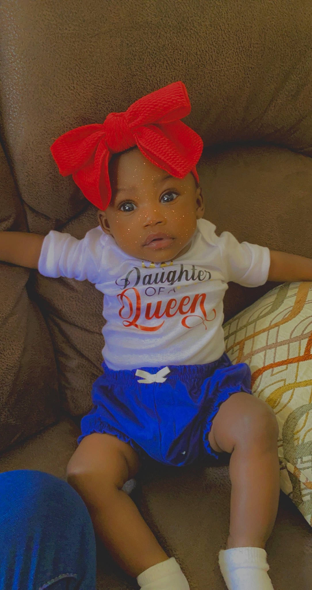 Cassidy is registered to the contest to win money with this photo: baby, baby_toddler_clothing, blue, cap, cheek, child, chin, clothing, comfort, eye, hat, head, human_body, joint, orange, person, skin, sleeve, t_shirt, thigh