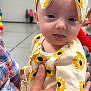 Embreigh joined the competition — help win amazing prizes! baby, child, sunflower, headband, outfit, plaid_shirt, person, indoor, hand, holding, curious_expression, tongue_out, balloons, background, blurred, people, clothing, cute, portrait, infant