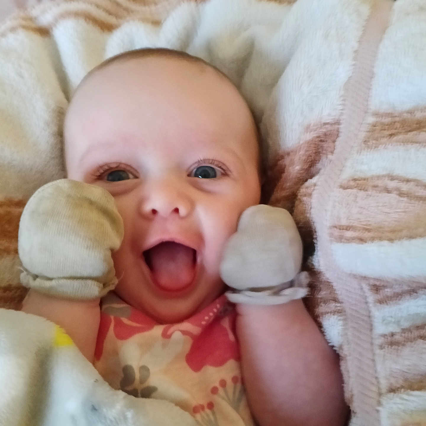 Eliana joined the competition — help win amazing prizes! baby, blanket, child, closeup, clothing, comfort, cozy, cute, expression, face, happy, head, indoors, infant, mittens, portrait, resting, skin, smiling, warm