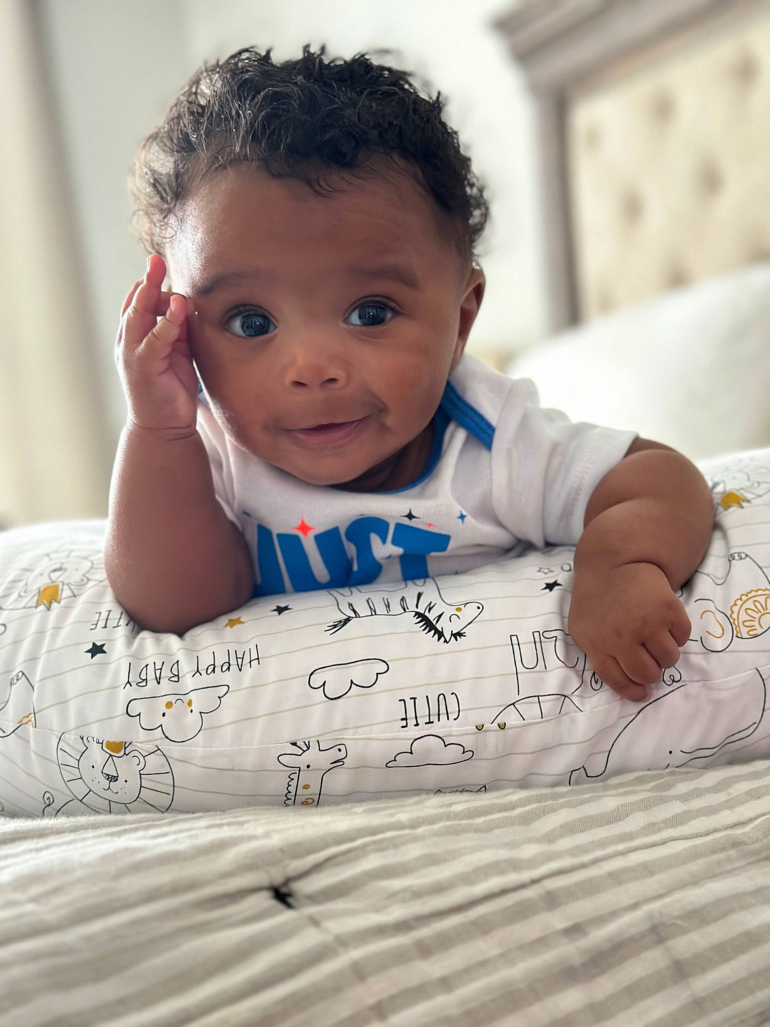 Jett is registered to the contest to win money with this photo: arm, baby, baby_toddler_clothing, cheek, child, comfort, face, finger, flash_photography, flooring, fun, handwriting, happy, head, linens, person, sitting, skin, t_shirt, toddler