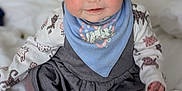 Eleanor is registered to the contest to win money with this photo: baby, bed, bib, blanket, blue_bib, cat_pattern, child, clothing, cute, dress, happy, indoor, infant, long_sleeve, pattern, portrait, rosy_cheeks, sitting, smiling, soft_lighting